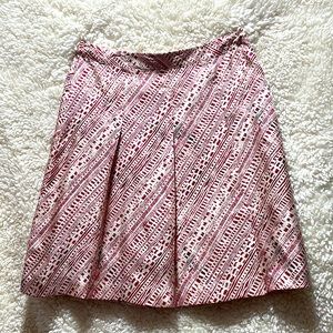 Pretty red pleated skirt. 100% silk with side zipper.